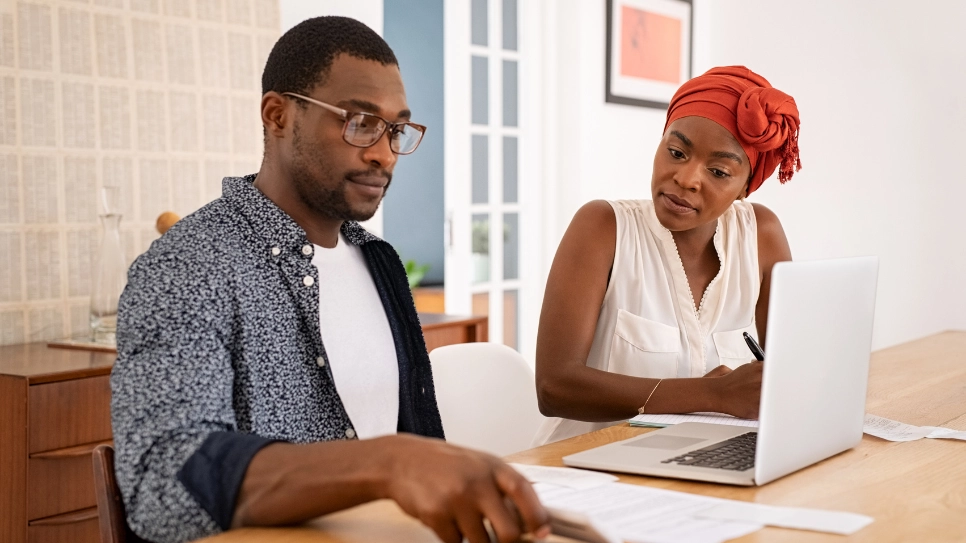 African couple looking at quotes, deciding on which service provider to choose.