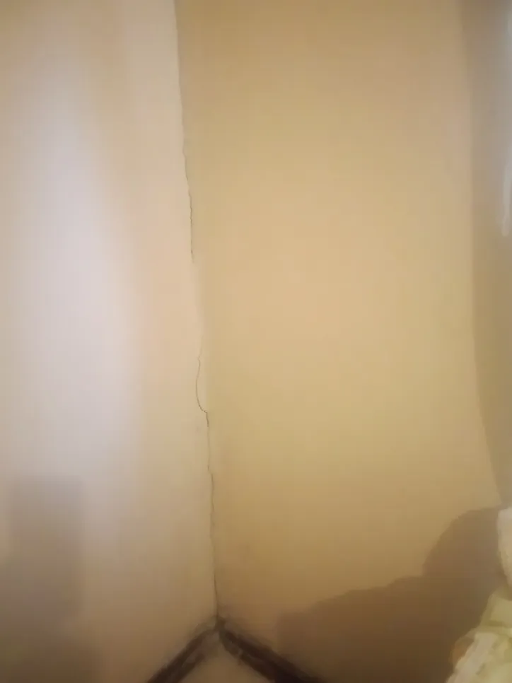 Visible crack along the corner of a beige wall, indicating potential structural movement or settling.