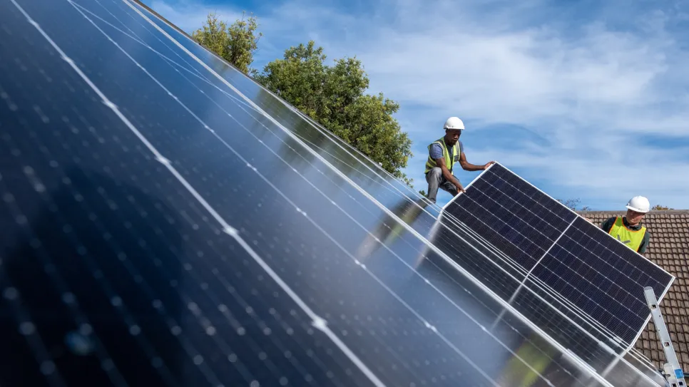 engineers install solar panels on the roof
