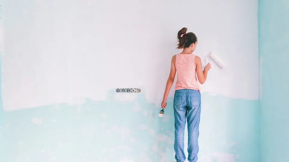 A child painting room light blue
