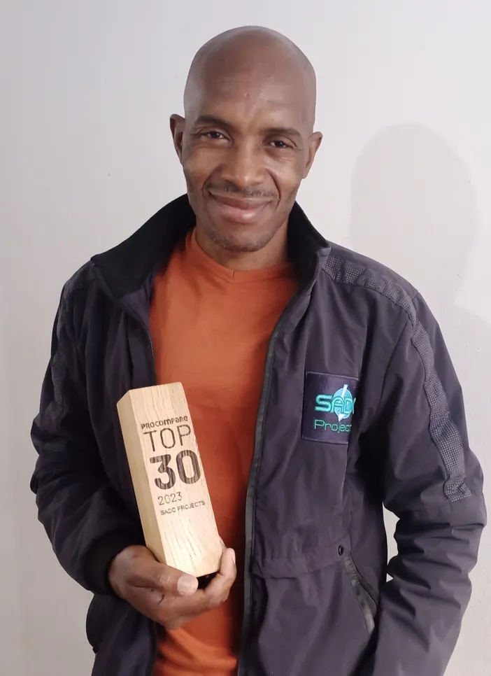 Charles from Sado Projects with the Procompare's Top 30 award.