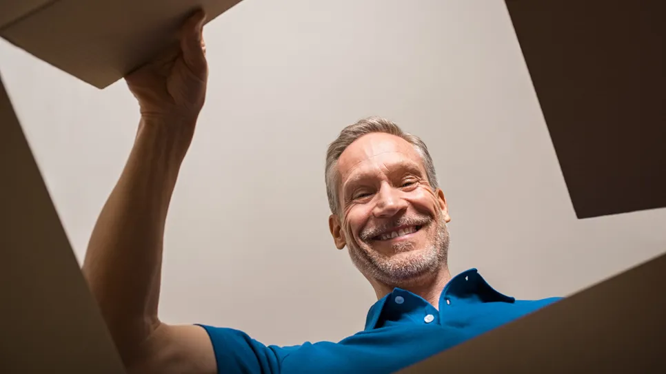 A satisfied customer looks into the box